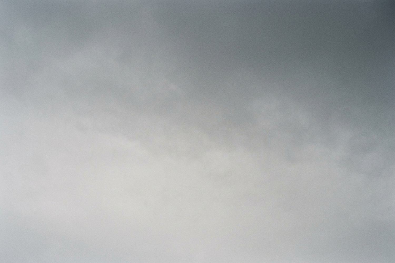 An unbroken overcast sky filling the frame, pale gray below and darker above.